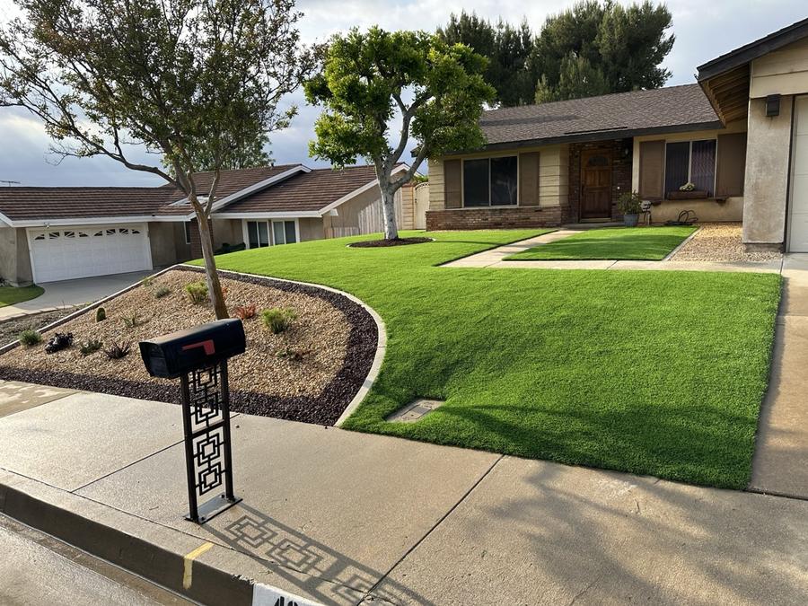 After: artificial turf + concrete curbing + decorative rock by Save Aqua Landscapes